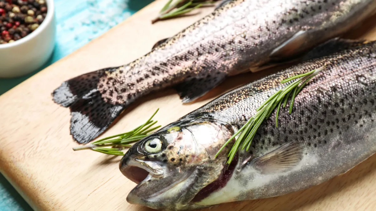 raw trout on a cutting board