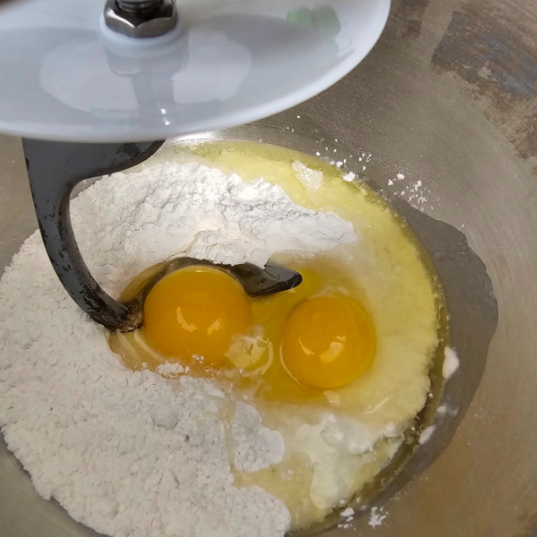 Eggs, flour, and salt in a mixer bowl ready to make spätzle Eggs, flour, and salt in a mixer bowl ready to make spätzle
