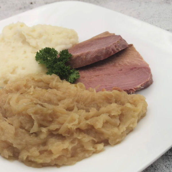 This peameal bacon recipe, that tastes like Kasseler, is cooked in your slow cooker together with sauerkraut for a real German meal. SO DELICIOUS and so easy.