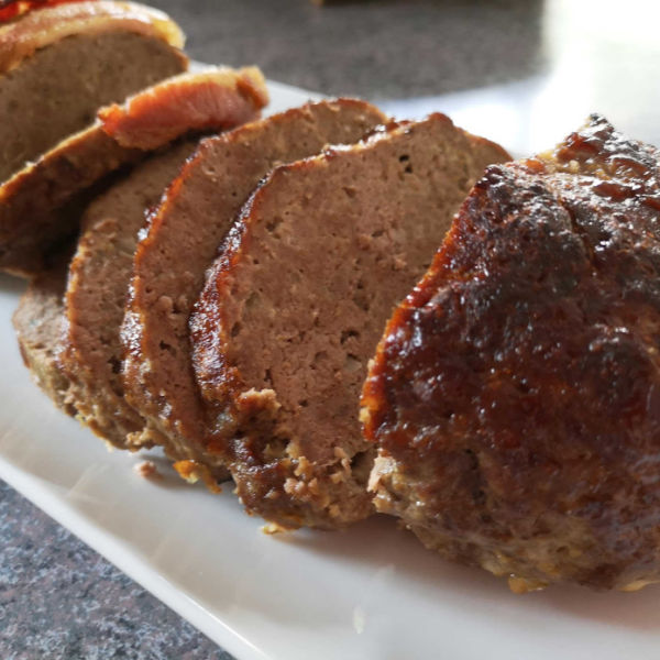 Oma's best German meatloaf recipe that's delicious served either hot or cold. This one's wrapped in bacon. WUNDERBAR with potato salad or mashed potatoes and gravy!.