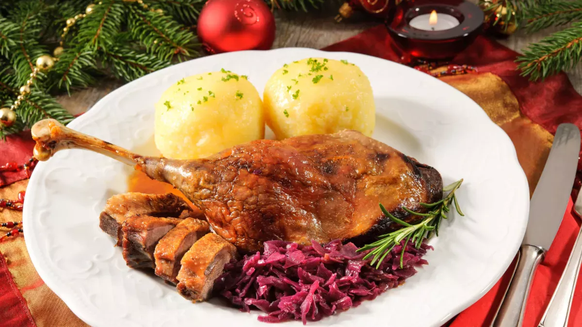 Roast duck leg with German potato dumplings and red cabbage for Christmas dinner.
