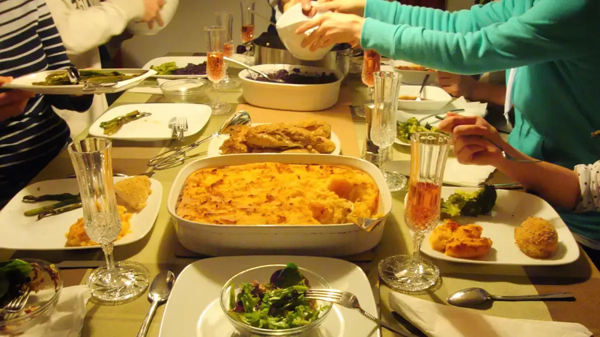 Family sharing a German dinner with several dishes served at the table