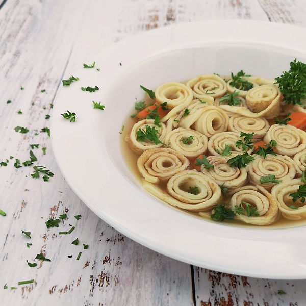 This Flädlesuppe, German pancake soup recipe, is a comfort food that many Germans recall from their childhood. A hearty broth poured over rolled crepe-like pancakes. Heavenly!