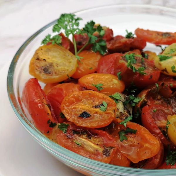 Learn how to roast cherry tomatoes in the oven. You’ll discover their natural flavor is concentrated and balanced by a gentle tang of acidity. It’s perfect for ‘out-of-season’ tomatoes!