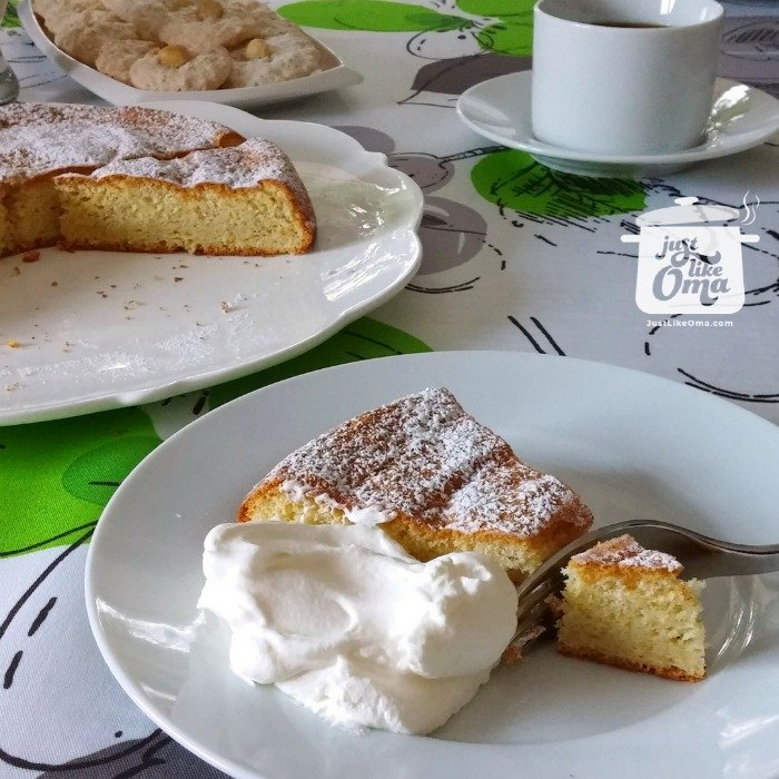 A piece of hazelnut cake served with whipped cream
