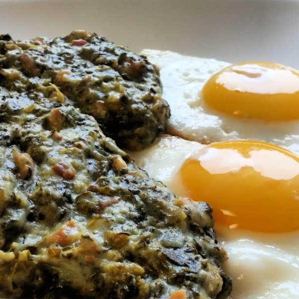 Kale served with some fried eggs. Add potatoes on the side, and you've traditional German dinner.