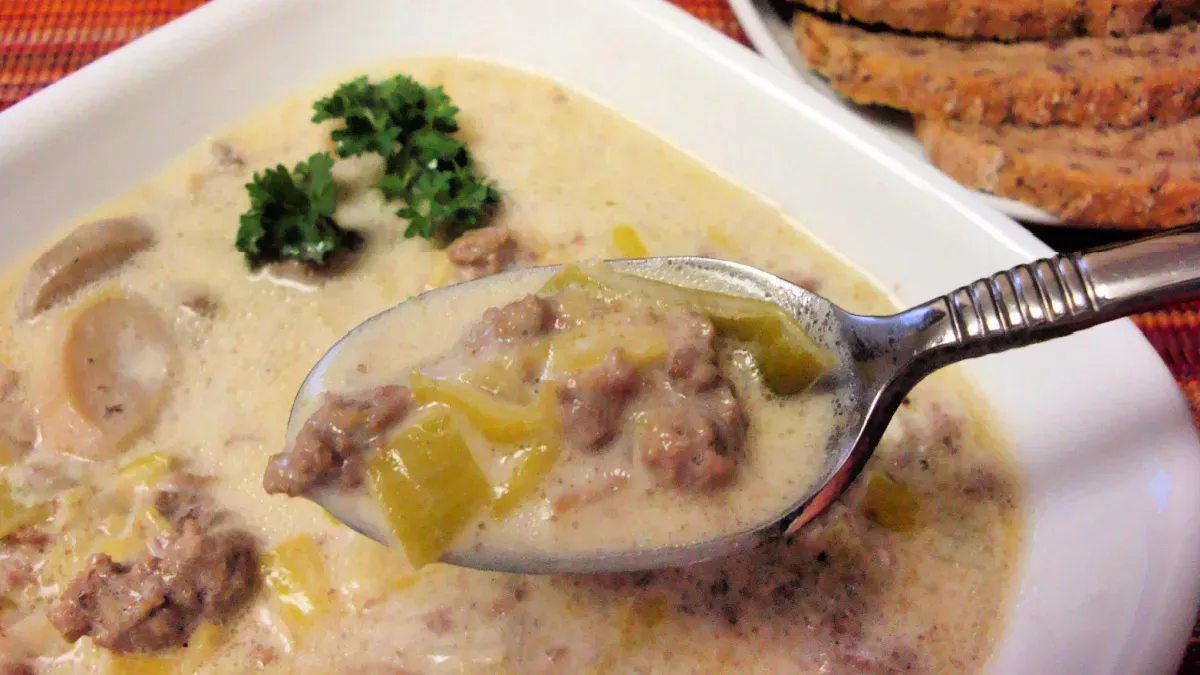 German Leek Soup (Lauchcremesuppe) Close-up of creamy ground beef and leek soup in a bowl