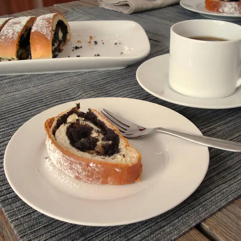 slice of poppy seed roll on white plate