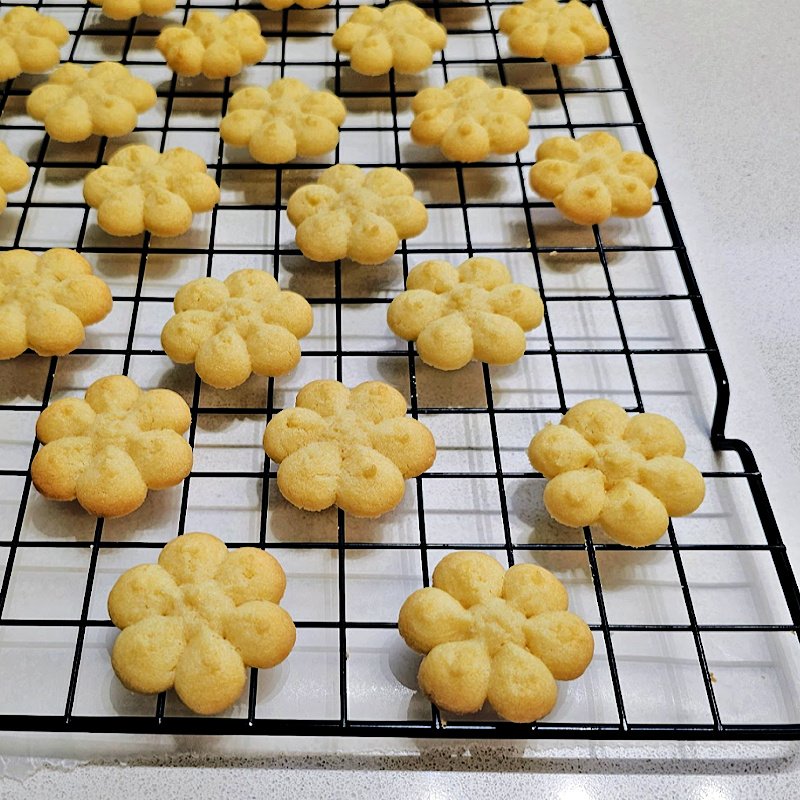 Spritz cookies cooking on cookie sheet