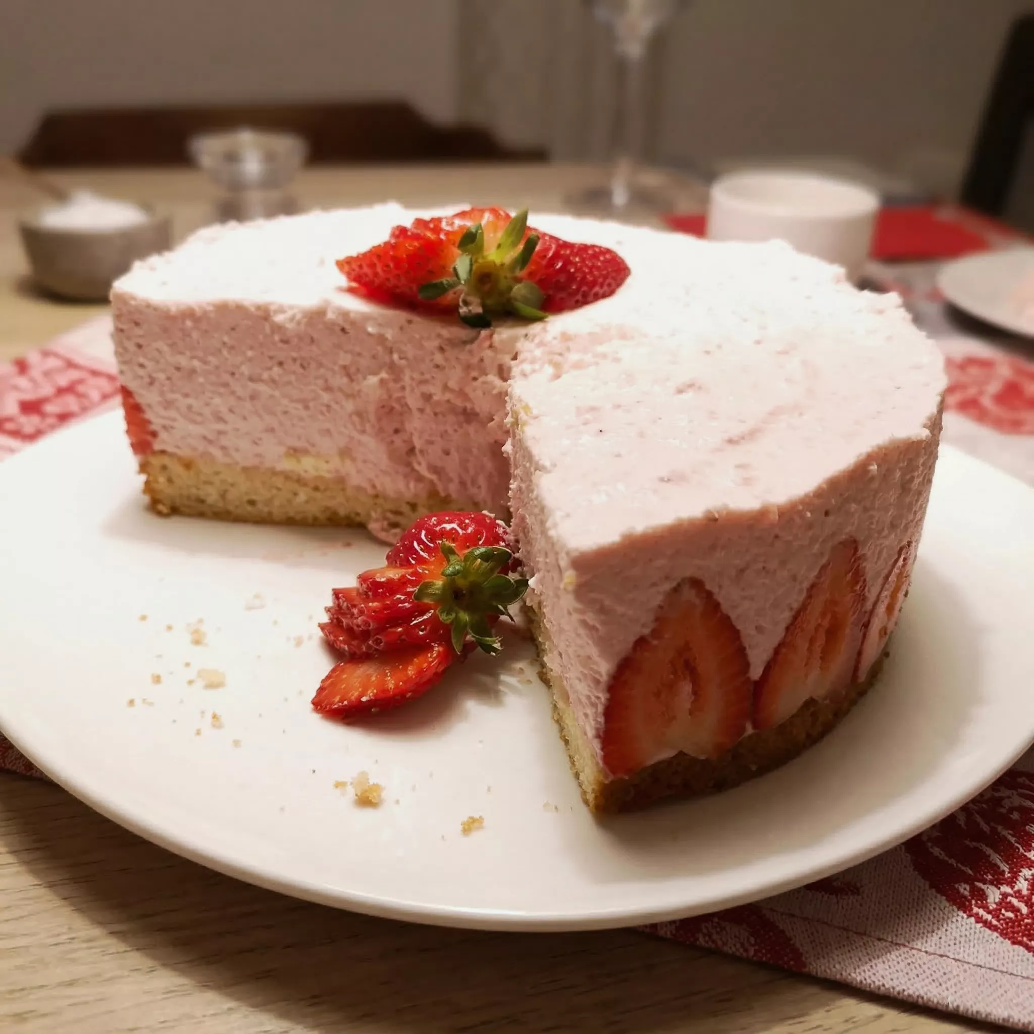 strawberry cream torte, sliced on white cake plate